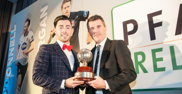 Richie Towell receives the player of the year trophy from Roy Keane